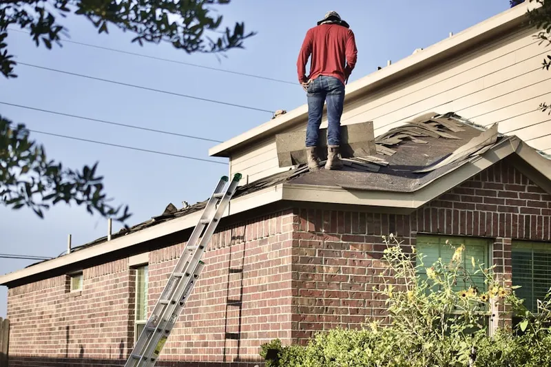 Professional roofer working on a residential roof in Guinea
